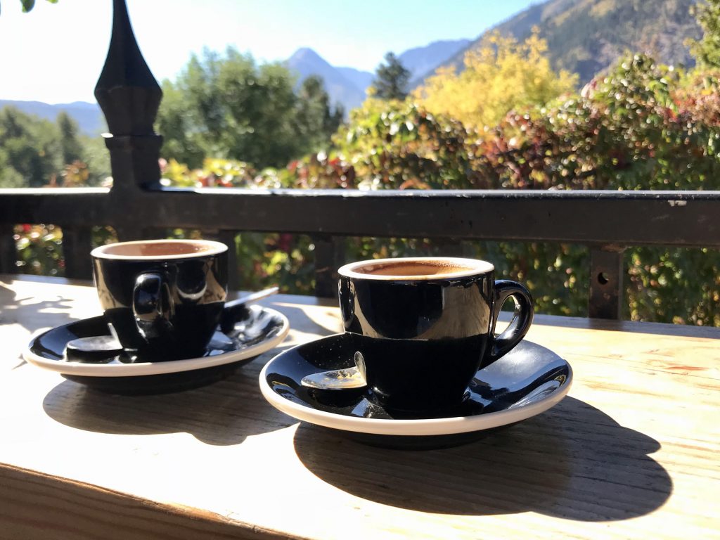 Two cups of espresso coffee on the terrace overlooking a mountain